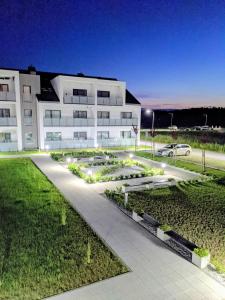 a building with a garden in front of it at Apartament 104/29 Sunset Resort Grzybowo in Grzybowo