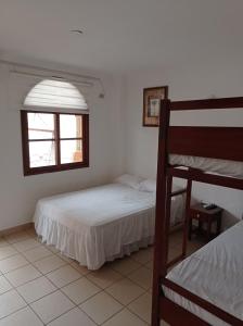a bedroom with two bunk beds and a window at My Best Stay Piedra del Mar in Puerto López