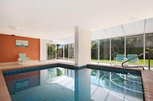 a swimming pool in a house with a swimming pool at Quarterdeck Apartments in Gold Coast