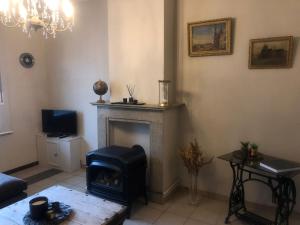 a living room with a fireplace and a couch at Vakantiehuisje aan de Ijzer in Diksmuide