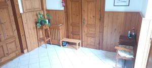 a room with wooden walls and a table and a chair at ŠulcBurg in Cetenov