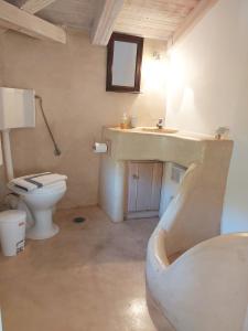 a bathroom with a sink and a toilet at Simos suites in Elafonisos