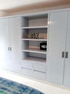 a white closet with white cabinets in a room at Ocean Villa in Puerto Morelos