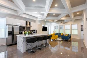 a kitchen with a counter and chairs in a room at Cute Cozy house close to major sporting events and restaurants in Houston