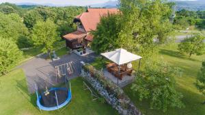 an overhead view of a house with a pool and an umbrella at Studio Apartment Karlo in Drežnik Grad