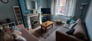 a living room with a couch and a fireplace at Ripon Street Lincoln in Lincoln