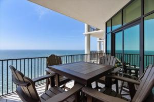 a table and chairs on a balcony with the ocean at The Oasis at Orange Beach Unit 3007 (formerly Phoenix West II) in Orange Beach