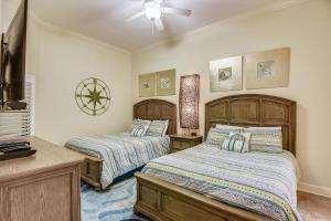 a bedroom with two beds and a ceiling fan at The Oasis at Orange Beach Unit 3007 (formerly Phoenix West II) in Orange Beach