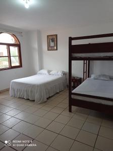 a bedroom with two beds and a window at My Best Stay Piedra del Mar in Puerto López