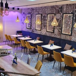 a row of tables and chairs in a restaurant at Hotel Siesta in Świebodzin