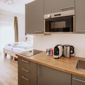 a kitchen with a counter top with a coffee maker at Hotel Arabella in Bad Nauheim