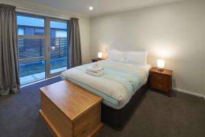 a bedroom with a bed and a large window at Majestic View - Lake Tekapo in Lake Tekapo