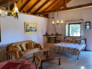 a living room with a couch and a table at Panos Cottage in Koinyra