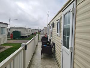 a row of chairs sitting on the side of a house at 6 Berth on Seaview 3 bedrooms Fanfare in Ingoldmells