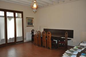 a dining room with a table and wooden chairs at Casa San Martino in Volta Mantovana