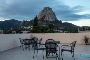a group of chairs and tables on a balcony with a mountain at Hotel Hai Do in Bernal