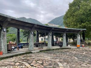 a pavilion with tables and chairs in a park at Ferry Head Leisure Club in Yuanshan +16 photos