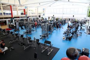 a gym filled with lots of equipment on a blue floor at Gold Coast Performance Centre in Gold Coast