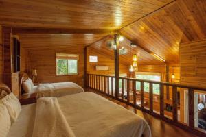 ZhudongにあるUpon The Hillの木造キャビン内のベッドルーム1室(ベッド2台付)