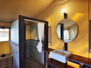 a bathroom with a sink and a mirror at Ara Dinawan Island Resort in Papar