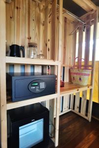 a small kitchen with a microwave in a cabin at Ara Dinawan Island Resort in Papar