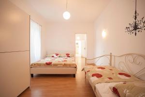 a bedroom with two beds and a chandelier at Dalmatian Garden - FREE parking - city centre in Šibenik