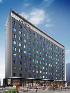 a large building with people walking in front of it at Hotel JAL City Toyama in Toyama