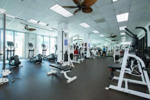 a gym with several treadmills and cardio machines at Beach Apartment at Condo-hotel in Miami Beach