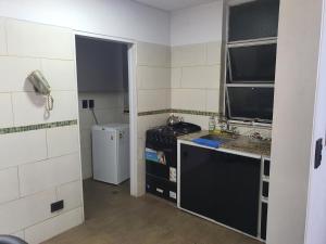 a small kitchen with a stove and a sink at Apartamento in Rosario +11 photos