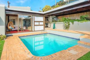 a swimming pool in the backyard of a house at Sun&Sea Villa in Cape Town