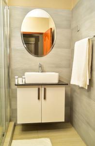 a bathroom with a sink and a mirror at El Sueno Homestay in Naivasha +32 photos