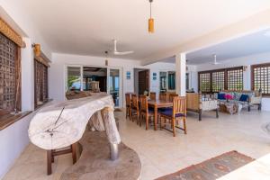 a living room with a table and chairs at Tequila Sunrise Pool Cabana-Diani Beach in Diani Beach