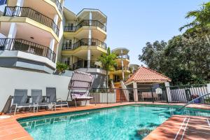 a swimming pool in front of a apartment building at Cosy apartment with ocean views, Sunshine Beach in Sunshine Beach