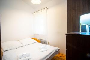 a bedroom with a bed with two white pillows at Domek Przy Plaży in Gąski