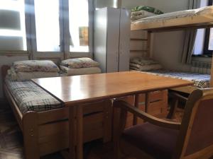 a dining room with a table and bunk beds at Hostel MIF in Ivano-Frankivsʼk