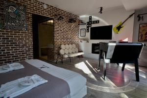 a bedroom with a bed and a desk and a piano at Snow Lodge Hotel Courchevel 1850 in Courchevel