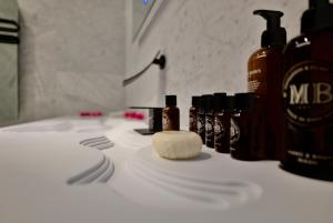 a counter with bottles of soap and a white counter top at Snow Lodge Hotel Courchevel 1850 in Courchevel +143 photos