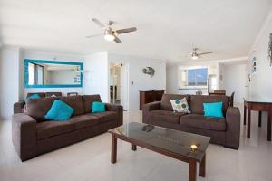 a living room with two couches and a coffee table at Surfers International Apartments in Gold Coast