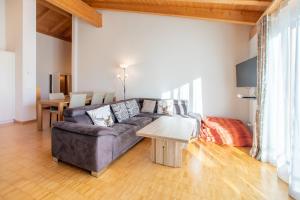 a living room with a couch and a table at Casa Miraval in Flims