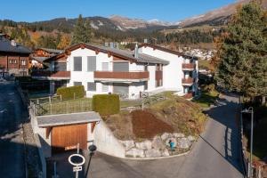an aerial view of a house with a hill at Casa Miraval in Flims