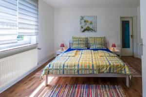a bedroom with a bed with a colorful bedspread at Ferienwohnung zum-vennwack in Monschau
