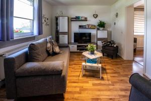 a living room with a couch and a table at Ferienwohnung zum-vennwack in Monschau