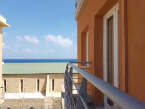 a balcony with a view of the ocean at Heraklion Old Port Apartments in Heraklio Town