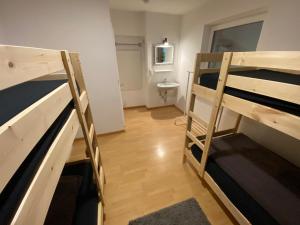 a room with two bunk beds and a bathroom at Group Stay near Bangerpark in Scharnitz