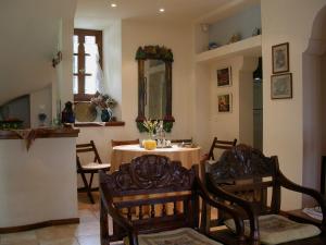 a dining room with a table and chairs and a mirror at Guesthouse Kalosorisma in Tsagarada