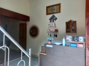 a stairway with a clock on the wall at OYO 90731 E-kreasi Home in Sekayu