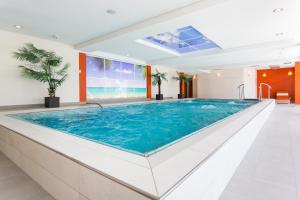 a large swimming pool in a building at Thermalhotel Gass in Bad Füssing