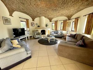 a large living room with couches and a fireplace at Villa OceanKokia in Albufeira