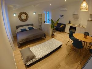 a bedroom with a bed and a living room with a table at STUDIO Canaille in Cassis