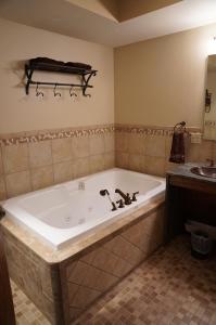 a bath tub in a bathroom with a sink at Mont du Lac Resort in Carlton